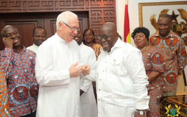 President Akufo-Addo interacting with  Rev. Father Andrew Campbell