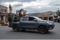 Members of the Amhara militia ride in the back of a truck in the city of Gondar, Ethiopia