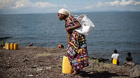 Residents walk to lake kivu for water in DRC