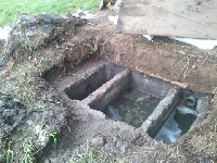 Damaged septic tank under repairs.