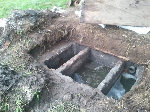 Damaged septic tank under repairs.