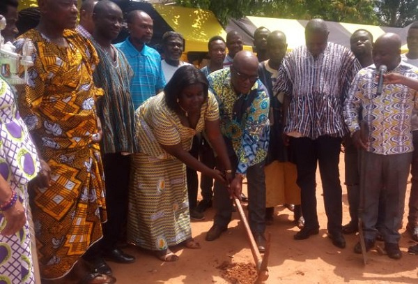 The MP, Okletey Terlabi being aided by the municipal health director to break grounds for the projec