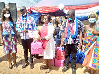 Mr. Samuel Nuertey Ayertey presenting a certificate to one of the graduates.