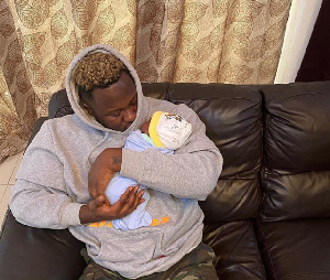 Rapper Medikal and child, Island Frimpong