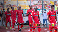 Asante Kotoko players walk onto the pitch for GPL game against Bechem United