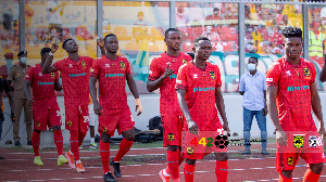 Asante Kotoko players walk onto the pitch for GPL game against Bechem United