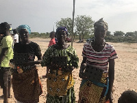 Some women of Ningo-Prampram holding their clean cook steel given to them by the foundation