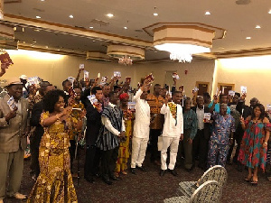 Attendants holding up copies of the book