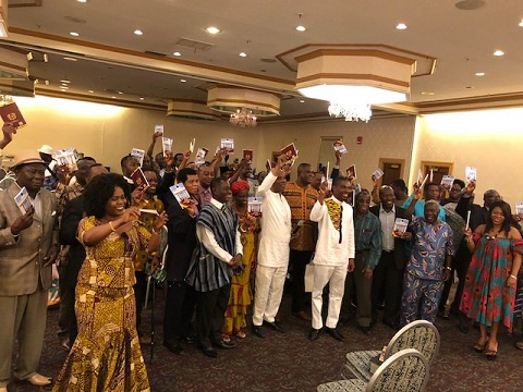 Attendants holding up copies of the book