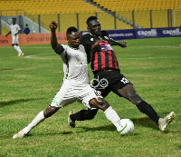 Joseph Esso in a tussle for the ball