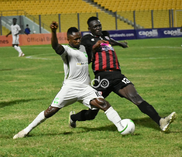 Joseph Esso in a tussle for the ball