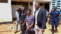 daniel Asiedu being escorted to prison after a court hearing