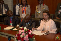 Prez Akufo-Addo signinging the treaties in the presence of the AU Commissioner for Social Services