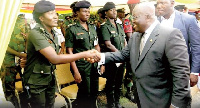 President Akufo-Addo in a hand shake with one of the female military officers at the event