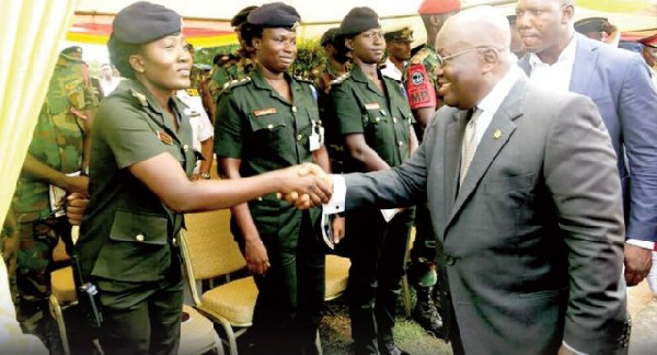 President Akufo-Addo in a hand shake with one of the female military officers at the event