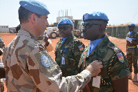 Force Commander decorates the parade Commander, Maj Samuel Yirenkyi