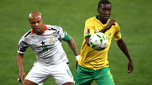 Black Stars captain, Dede Ayew (L) in action against South Africa