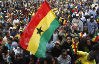 File photo: Ghanaians holding the country's flag