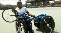 An athlete in a pose with her new racing chair