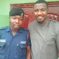 Actor John Dumelo in a pose with the Police officer who brutalized the nursing mother