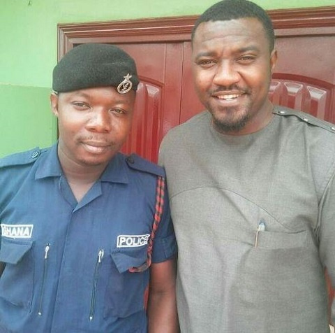 Actor John Dumelo in a pose with the Police officer who brutalized the nursing mother