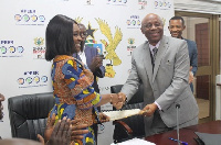 Deputy Finance Minister, Abena Osei Asare exchanging documents with the AfDB representative