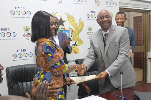 Deputy Finance Minister, Abena Osei Asare exchanging documents with the AfDB representative