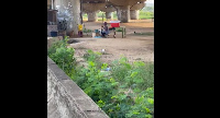 A screengrab of a woman pounding fufu under the overpass