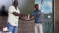 Sasu (R) receiving his prize from Mark Cofie, Vice-captain of the Achimota Golf Club