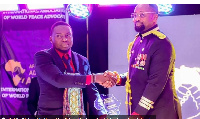 Alhaji Yussif (left) receiving his award from Dr Samuel Ben Owusu