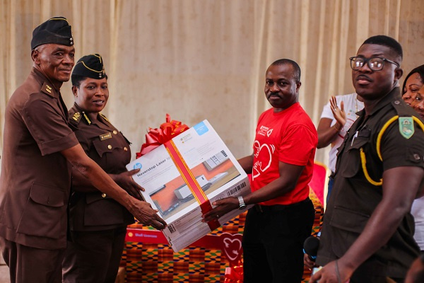 Kwasi Barfi Vivo Energy's Asset Intergirty Manager (clad in red) presenting the items to authority