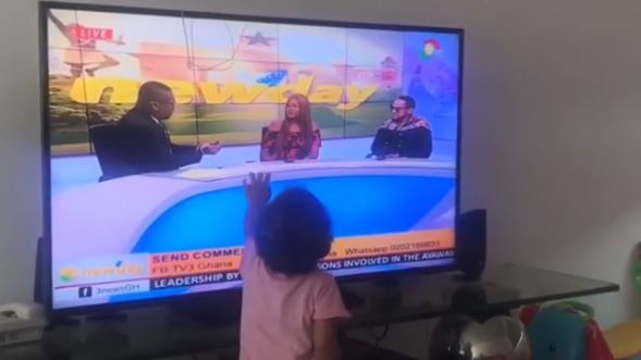 Baby Ryn touches the television as she sees her mum