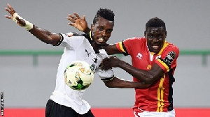 Uganda's forward Muhammad Shaban (right) challenges Ghana's defender John Boye(L)