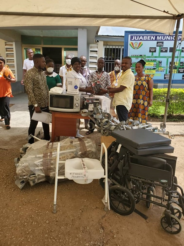 The Appianyinasehene (2nd R) presenting one of the items to officials of the hospital