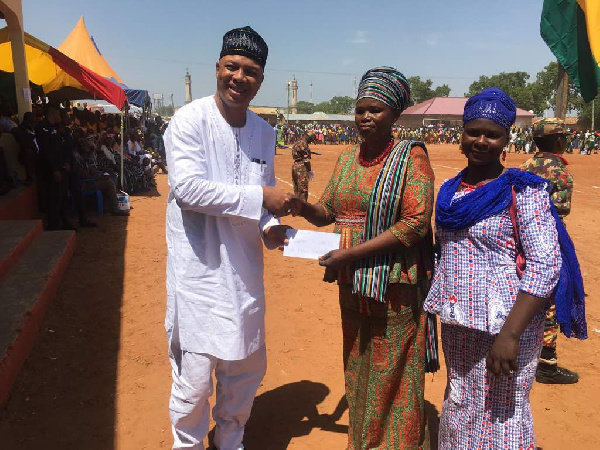 MP for Damongo Constituency, Adam Mutawakilu handing over the cheque to support CAMFED