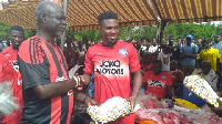 Jerry Akaminko giving a gift to his childhood coach