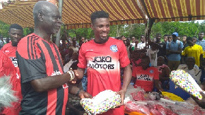 Jerry Akaminko giving a gift to his childhood coach