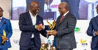 Moses Kwasi Baiden Jnr receiving his award from John Dramani Mahama