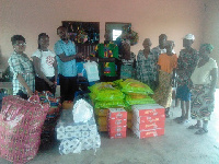 Felix Kwabena Dwomor (L) presenting items to Togbe Jacob Ezor, the Chief of the Village