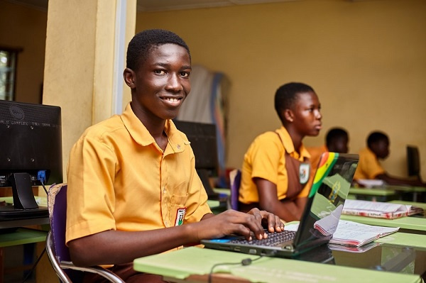 Photo of a student typing on a laptop