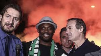 Essien with officals of Panathinaikos before he signed his contract with them