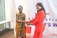 Mercy Adu (left) receiving her present from vodafone