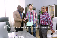 Kurt E.S. Okraku (L) with officials of Ezzy Paints