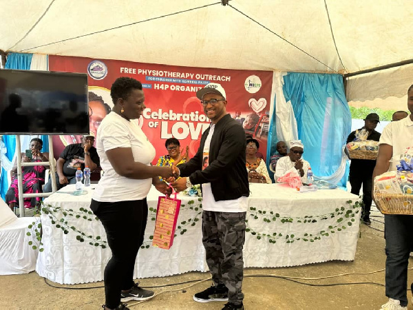 Bishop Dr Charles Cofie Hackman presenting a gift to Mrs Ellen Affam-Dadzie