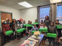 Kids happily display their gift boxes from Toronto Star