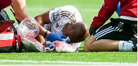 Dede lying on turf injured