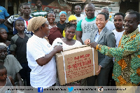 Dr. Zanetor Agyeman-Rawlings presenting a machine to one of the beneficiaries