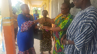 DCE for Nadowli-Kaleo, Katherine T Lankono handing the keys to the school authorities