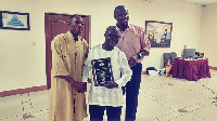 Frank Ofori and Roger Crawford presented plaque to  Kobby Owusu Afriyie