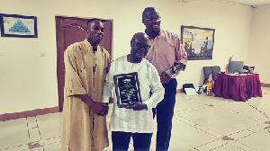 Frank Ofori and Roger Crawford presented plaque to  Kobby Owusu Afriyie